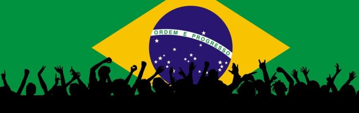 Brazilian flag with silhouettes of people in movement in front